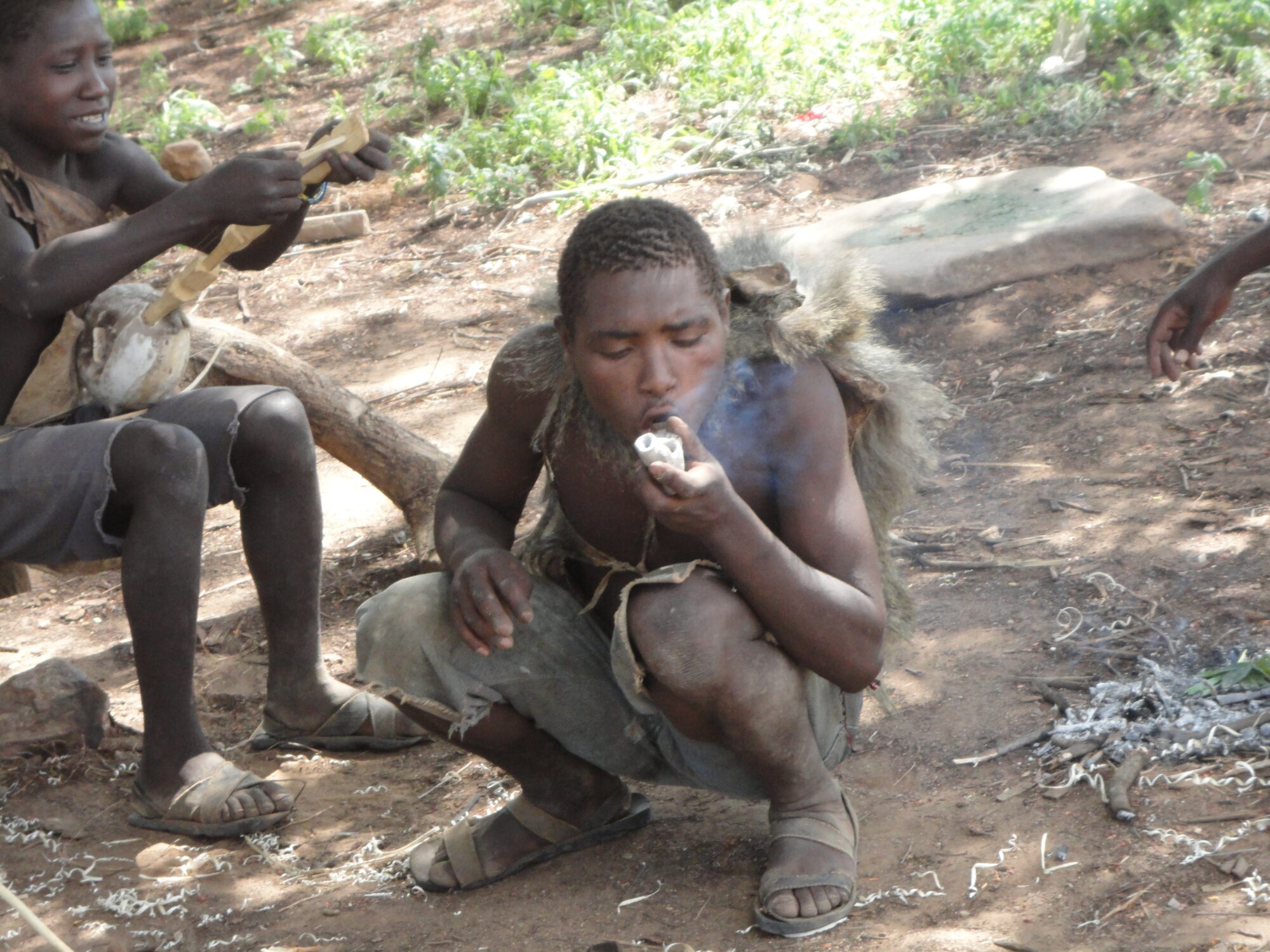 Travel Medicine - Hadzabe smoking a traditional homemade pipe