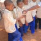 Travel Medicine - Boys at a muslim school giving a urine sample for testing