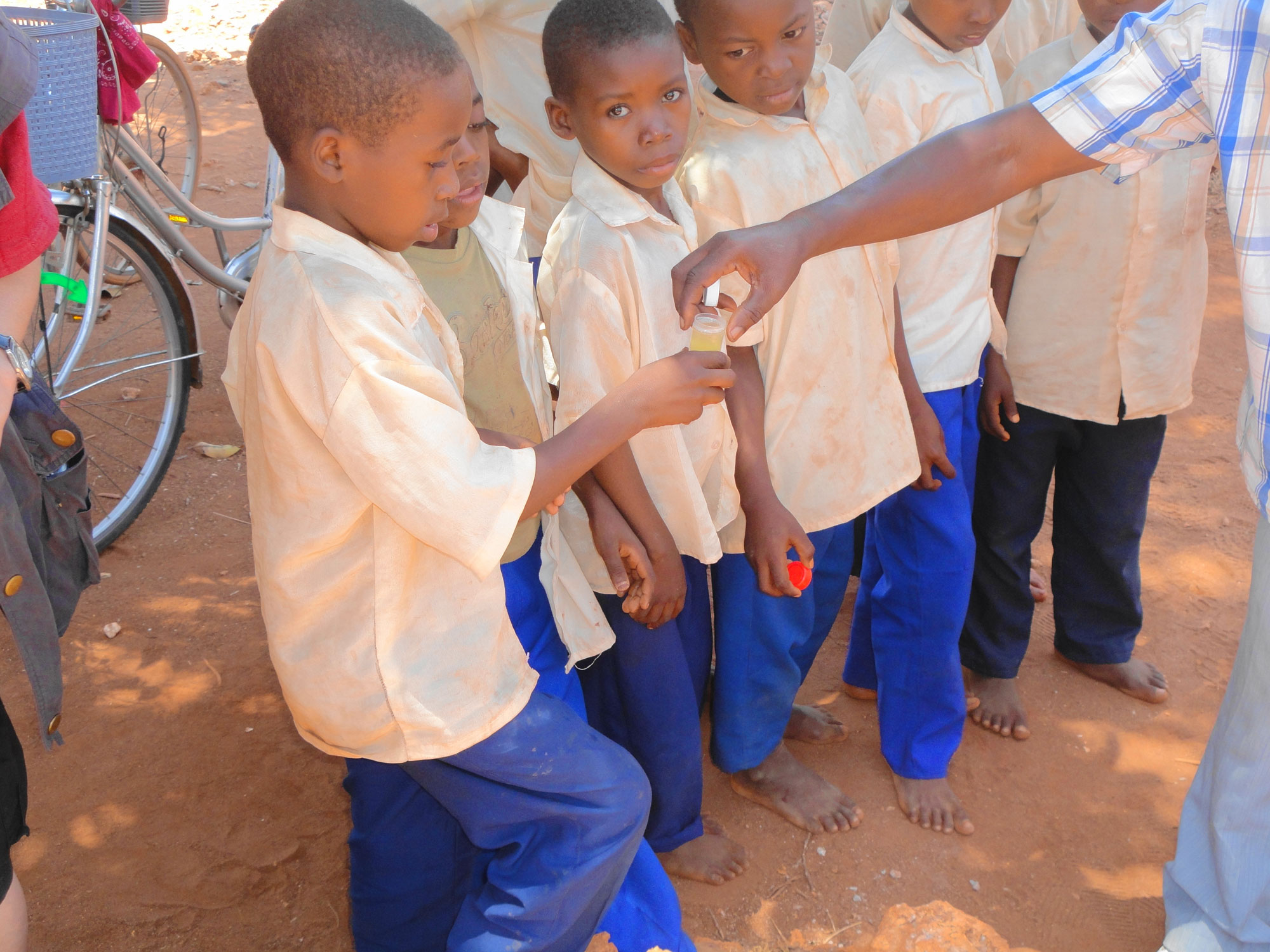 Travel Medicine - Boys at a muslim school giving a urine sample for testing